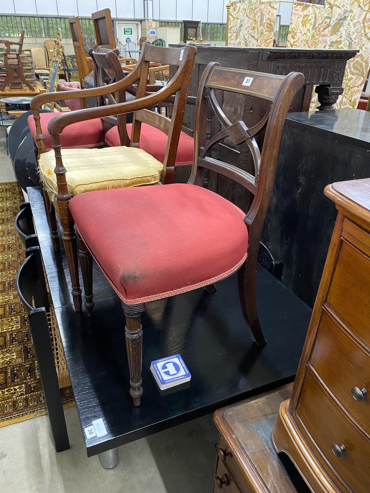 Four Regency brass inlaid mahogany dining chairs one with arms, together with a Regency caned seat elbow chair.